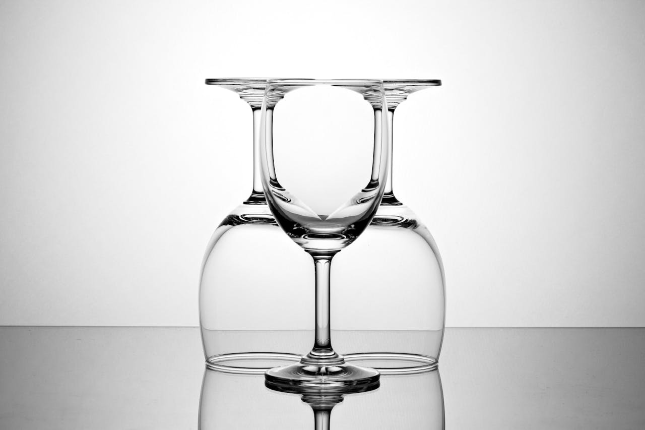 Elegant display of inverted and upright wine glasses showcasing symmetry and reflection.